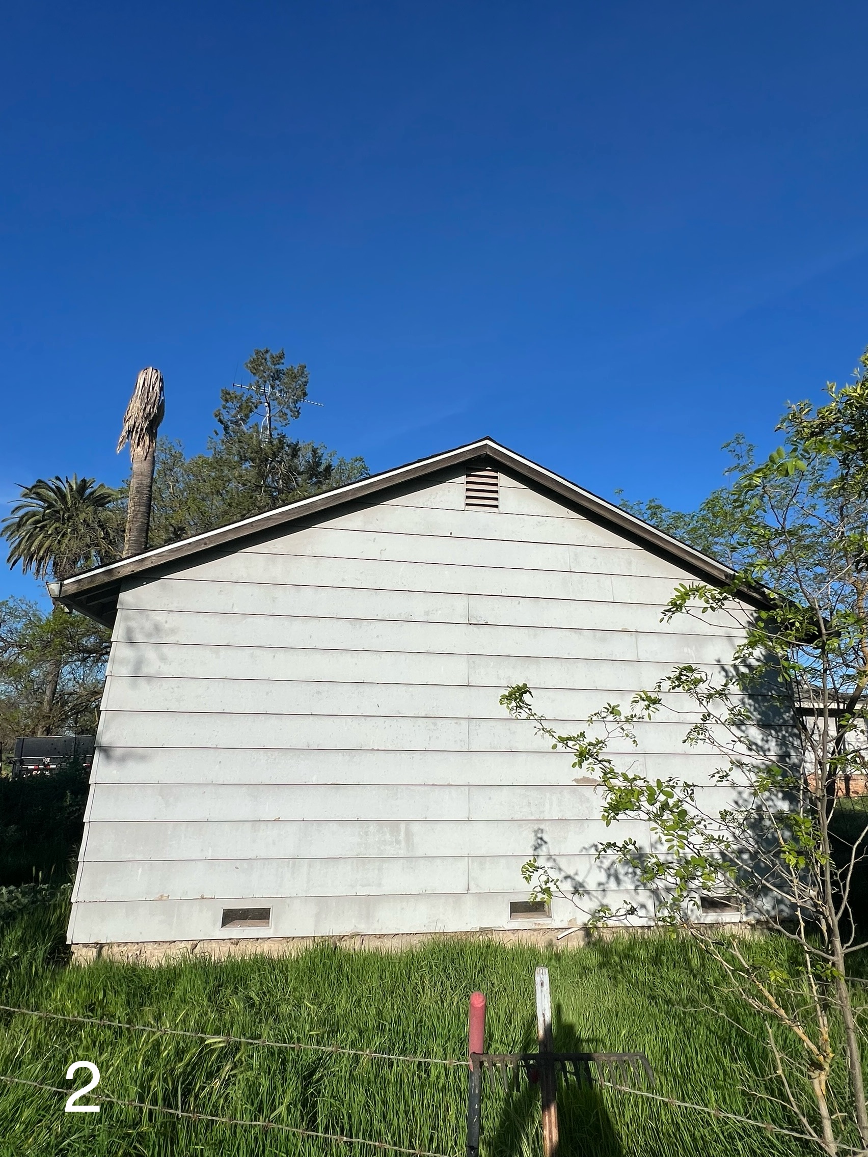 Before: Old worn siding on the rear gable of the Yuba City home
